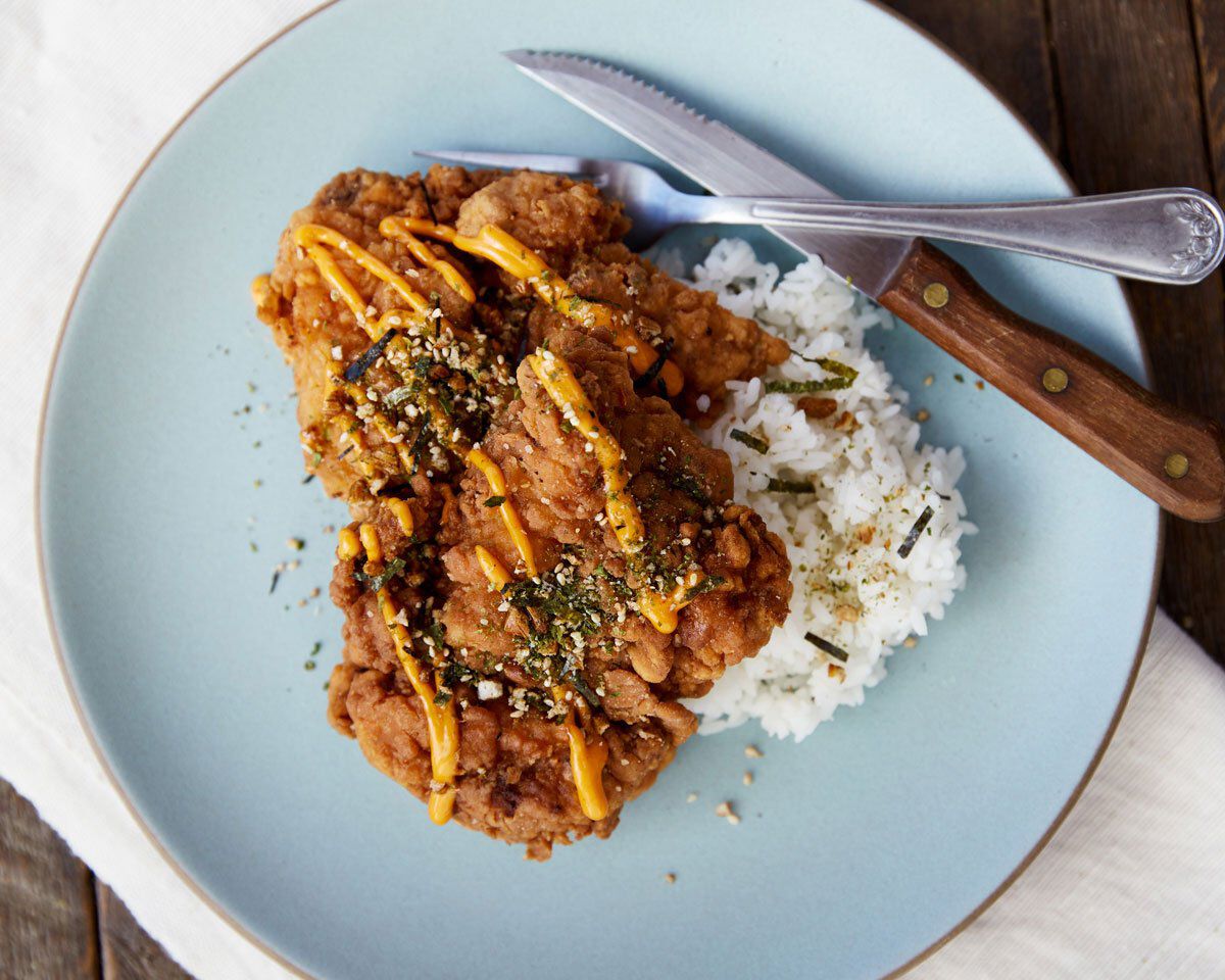 Crispy Mochiko chicken with Nori Furiake crumble served with white rice on a light blue plate.
